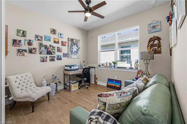 Guest Bedroom 1 with wood tiled floors and ceiling fan