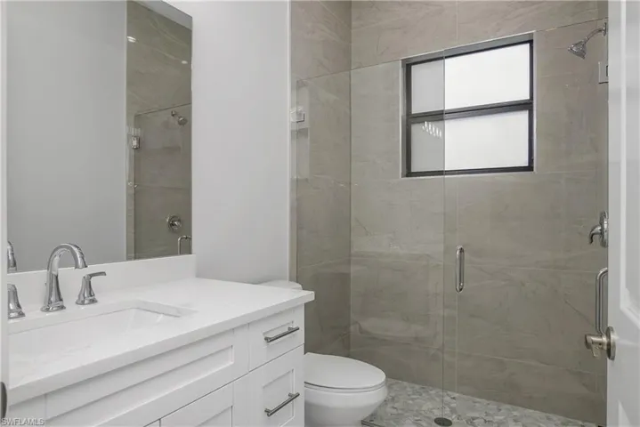 Bathroom featuring vanity and a stall shower