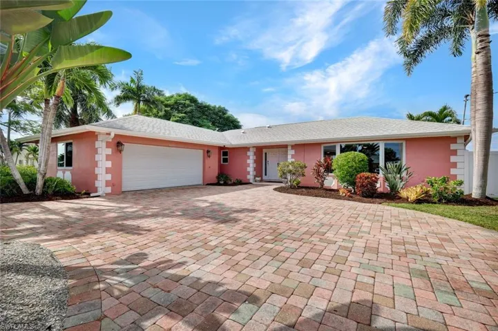 Ranch-style home with a garage, stucco siding, decorative driveway, and roof with shingles