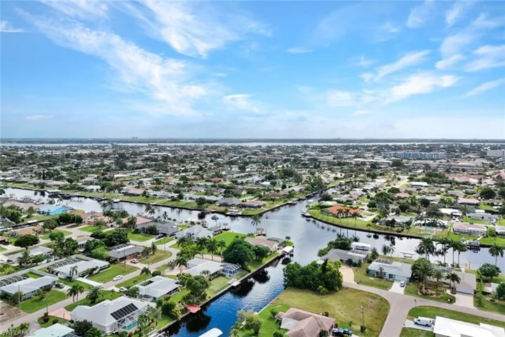 Aerial view of residential area featuring a nearby body of water