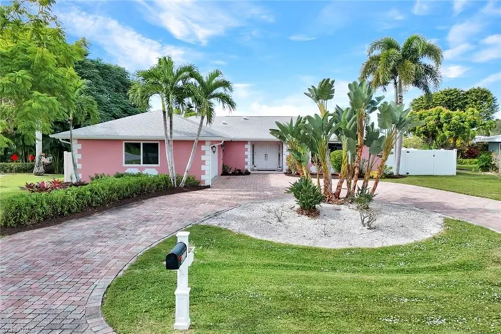 Ranch-style home featuring a gate, curved driveway, stucco siding, and roof with shingles