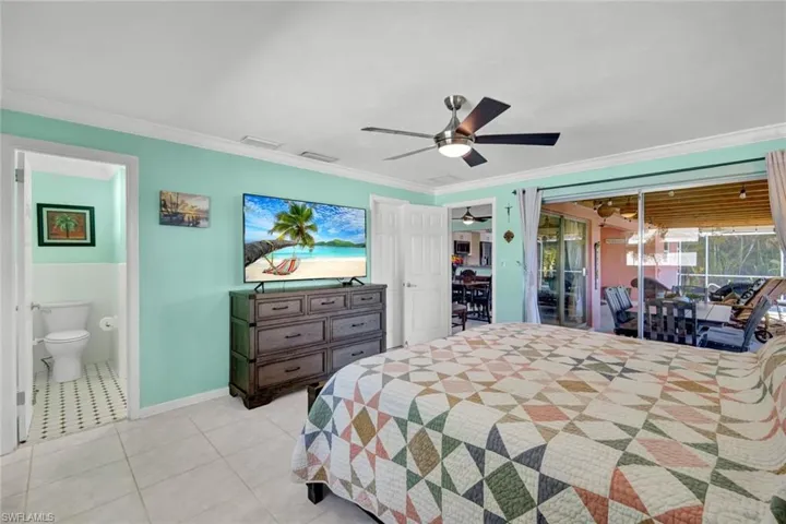 Bedroom with access to exterior, ceiling fan, crown molding, and light tile patterned floors