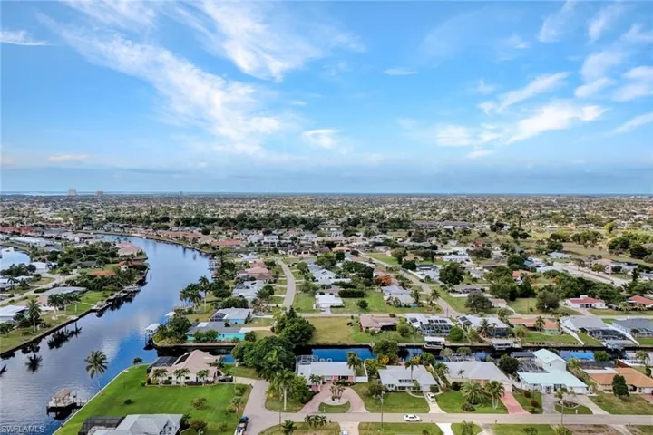 Aerial view of residential area featuring a large body of water