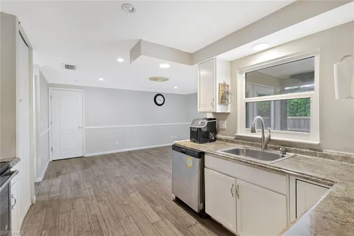 Kitchen has pantry and opens to family room/den.