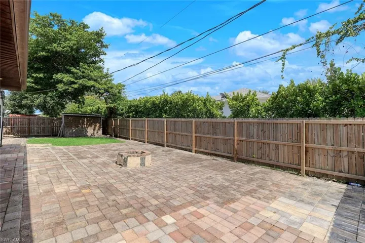 Brick paved lanai space, and fenced rear yard.