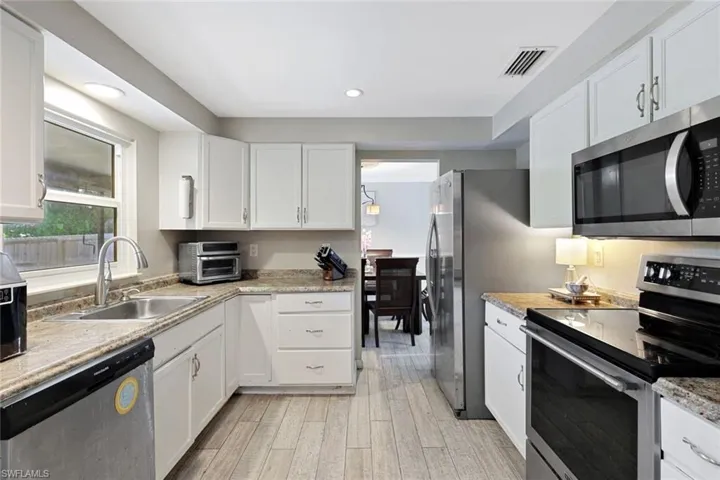 Solid surface counter tops and window to screened lanai.