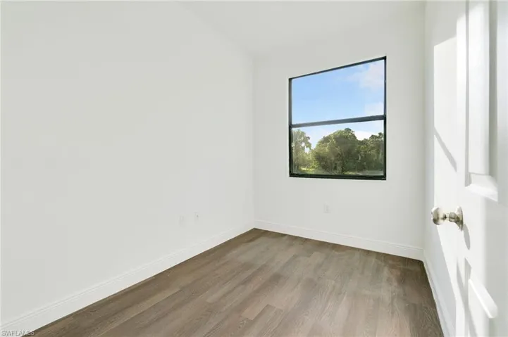 Empty room featuring wood-type flooring