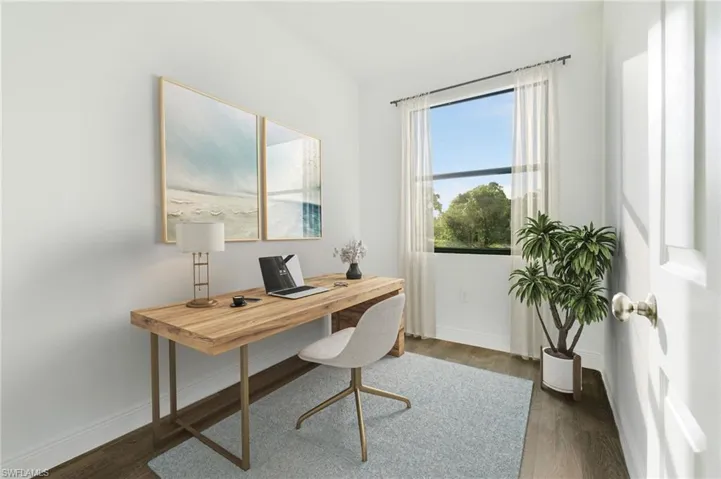 Home office with dark hardwood / wood-style floors
