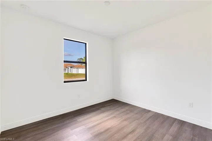 Unfurnished room featuring hardwood / wood-style flooring