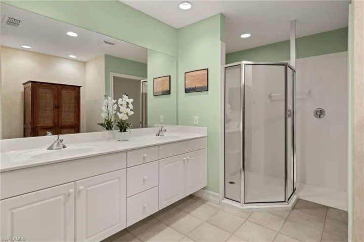 Primary bath with dual sinks and walk in shower.