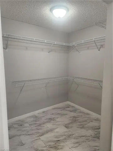 Spacious closet with marble finish floor
