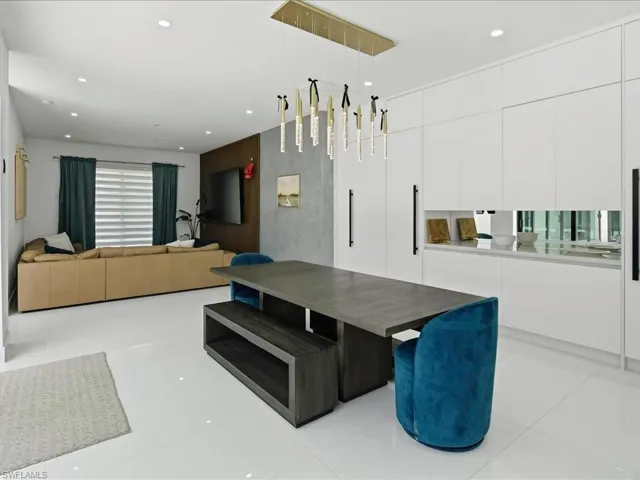 Open-concept living space featuring high-gloss white tile flooring