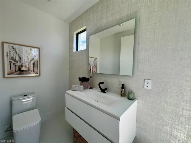 Contemporary vanity with integrated sink, matte black faucet, and two storage drawers