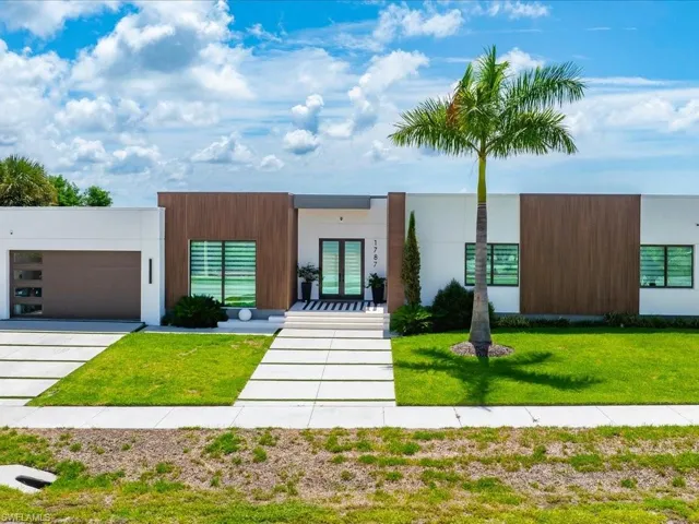 Contemporary exterior featuring white stucco and wood-finish accent panels