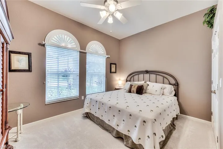 Bedroom with light carpet and ceiling fan