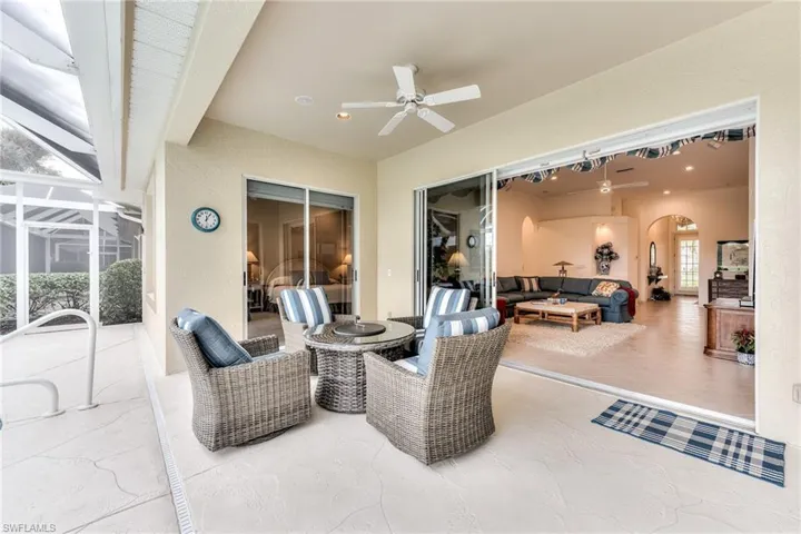 View of patio / terrace with ceiling fan, glass enclosure, and outdoor lounge area