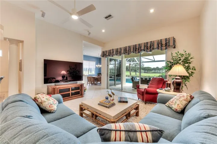 Living room featuring ceiling fan and light tile patterned floors