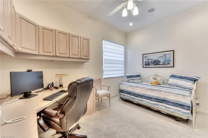 Carpeted bedroom with ceiling fan