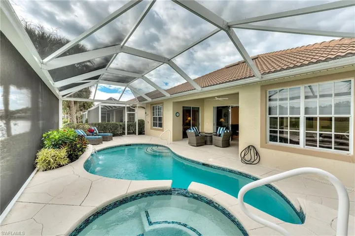 View of pool featuring an in ground hot tub, a patio area, ceiling fan, and an outdoor hangout area