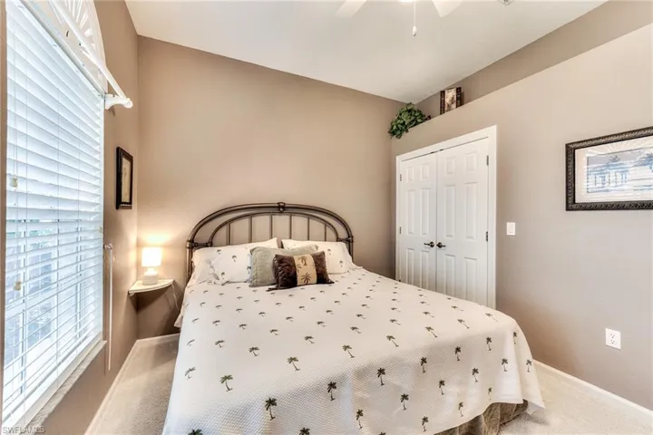 Bedroom featuring ceiling fan, a closet, and carpet flooring