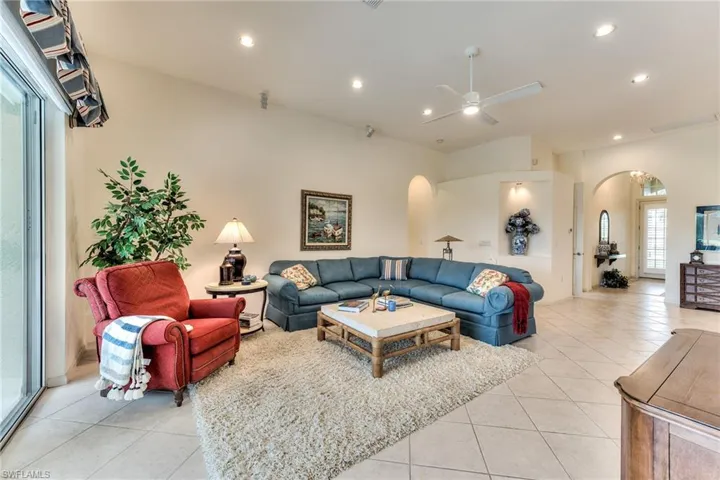 Tiled living room featuring ceiling fan