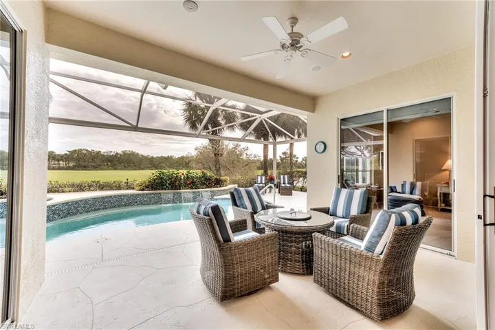 View of patio / terrace with ceiling fan, an outdoor living space, and a lanai