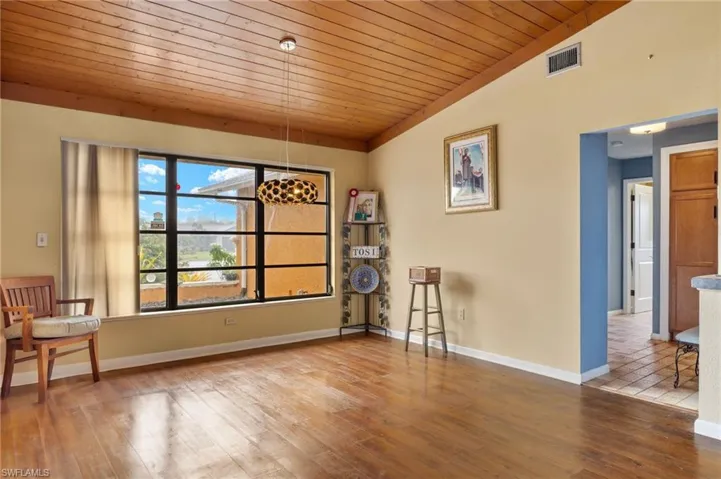 Unfurnished room featuring wood ceiling, wood-type flooring, and lofted ceiling