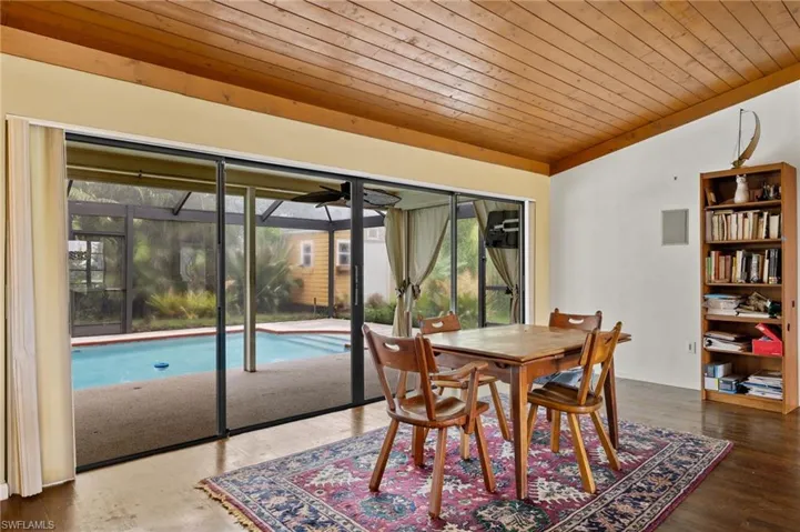 Dining space with wood ceiling, dark wood-type flooring, and lofted ceiling