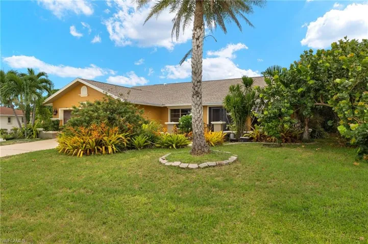 Ranch-style house with a garage and a front yard