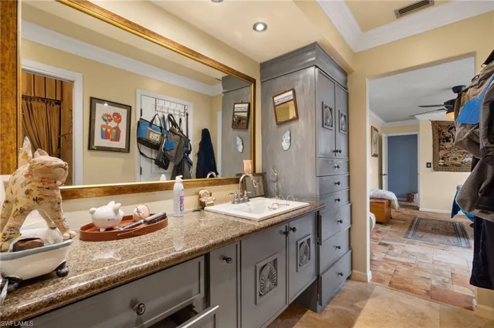 Bathroom with ceiling fan, crown molding, tile patterned flooring, and vanity