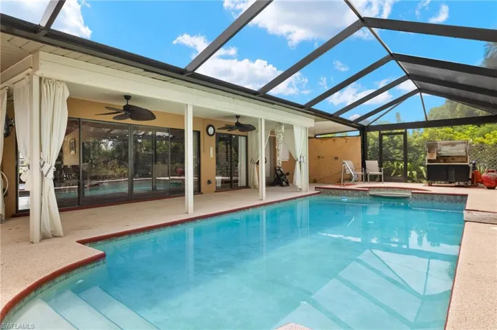 View of pool featuring ceiling fan, a patio, and a lanai