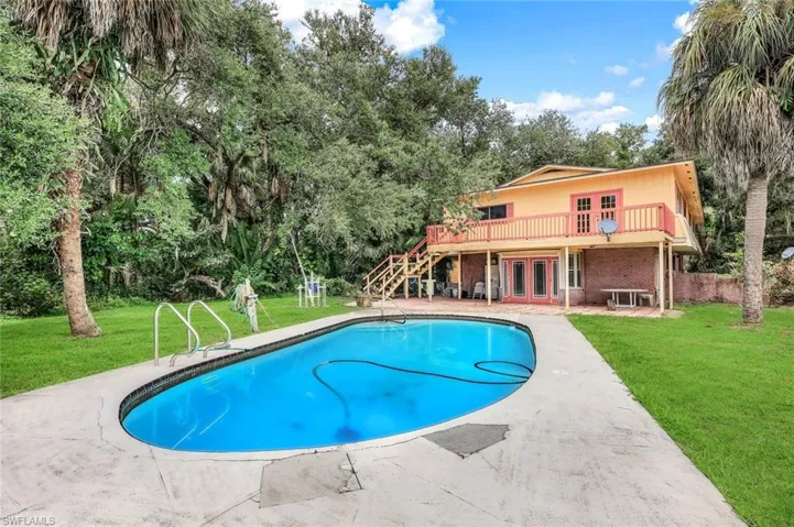 View of swimming pool with a lawn and a patio area
