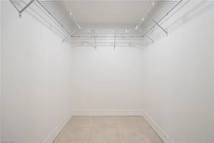 Spacious closet featuring light tile patterned floors