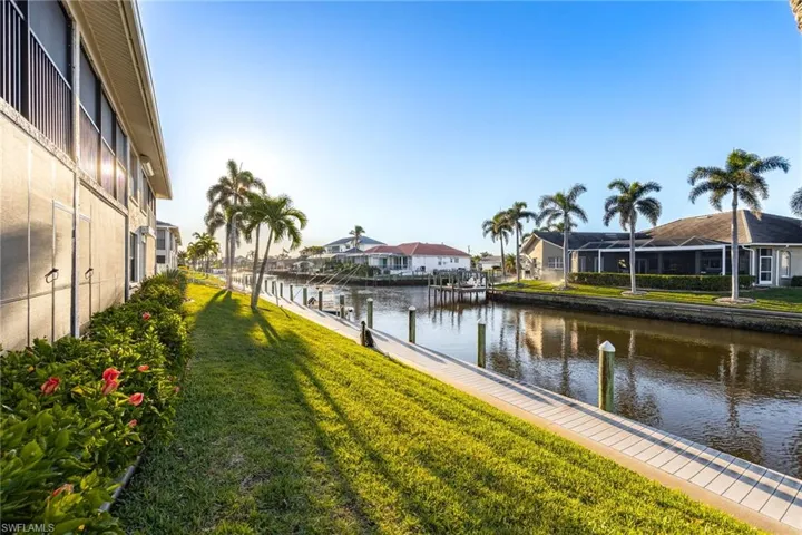Water view with nearby suburban area and a dock