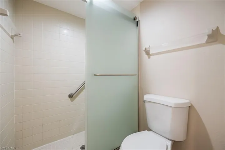 Bathroom with a stall shower and toilet