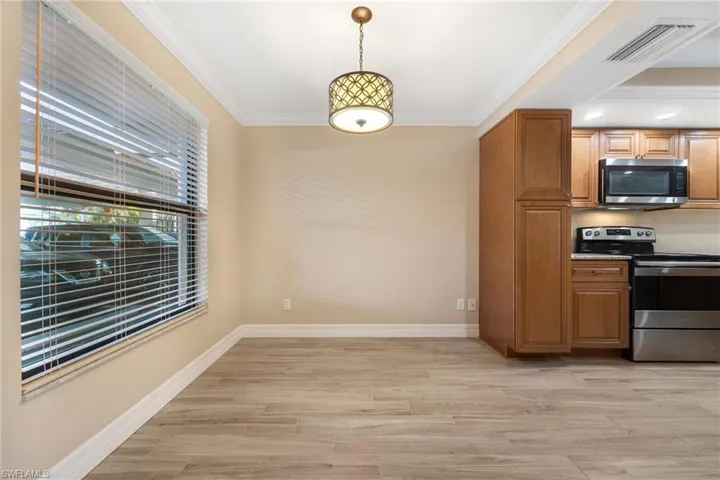 Unfurnished dining area featuring crown molding and light wood finished floors