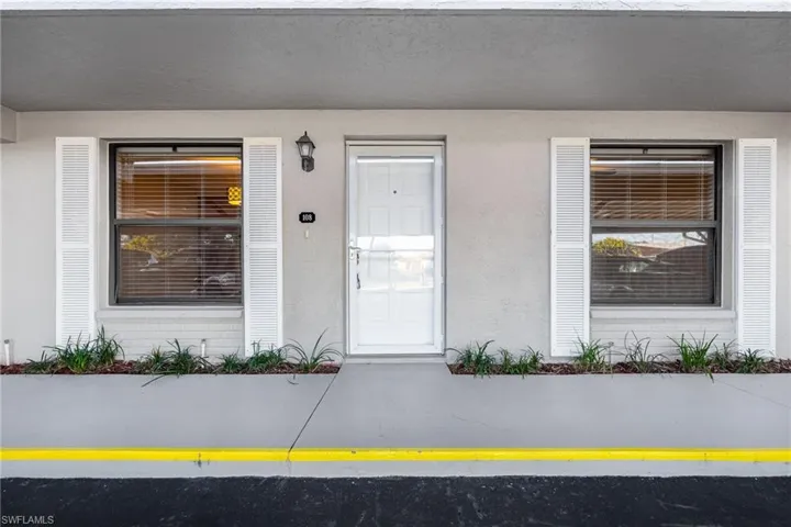 View of exterior entry featuring stucco siding