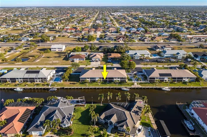 Aerial overview of property's location with nearby suburban area and a nearby body of water