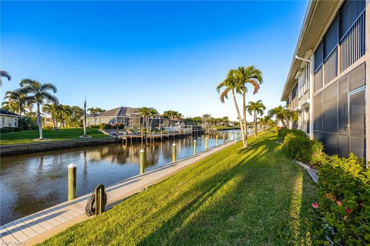 Dock with a water view, a yard, and a residential view