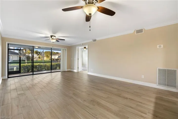 Living room featuring molding and light wood-style flooring