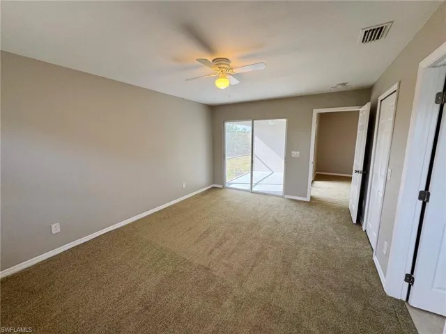 Unfurnished bedroom with access to exterior, carpet floors, and ceiling fan