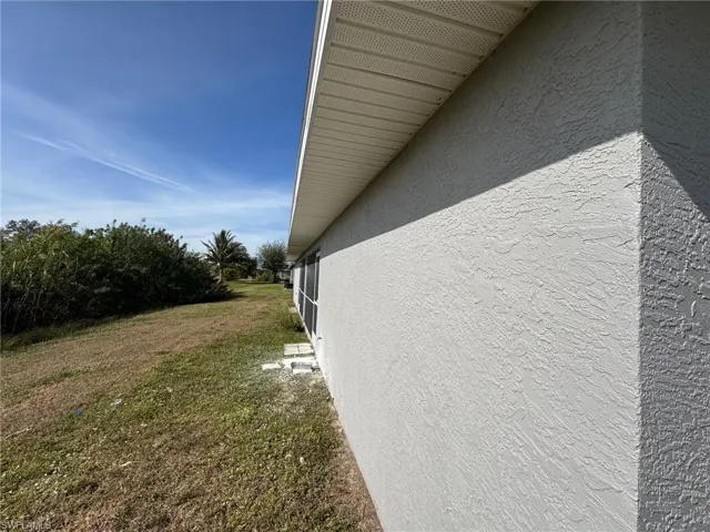 View of property exterior with a lawn