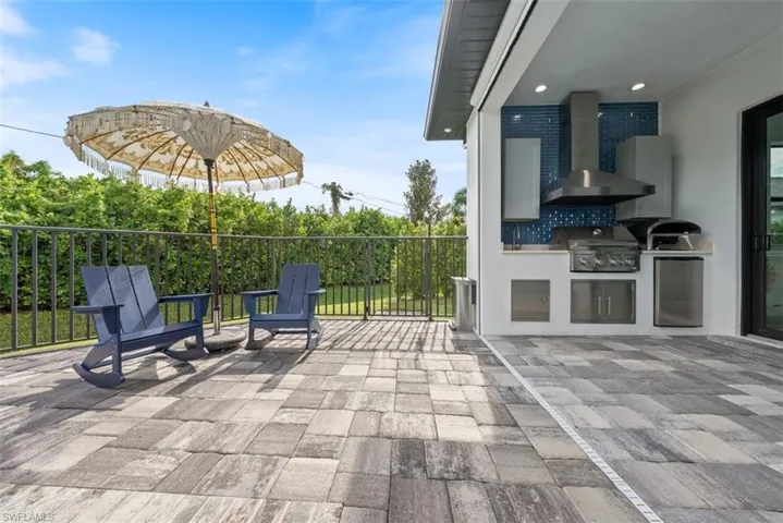 View of patio / terrace with area for grilling, sink, and a grill