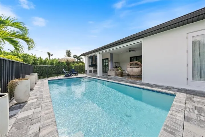 View of pool with ceiling fan and a patio area