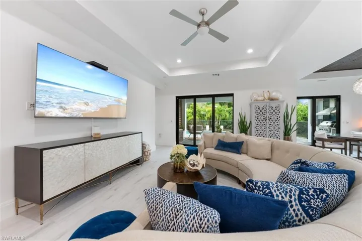 Living room with impact sliders leading to the pool area.