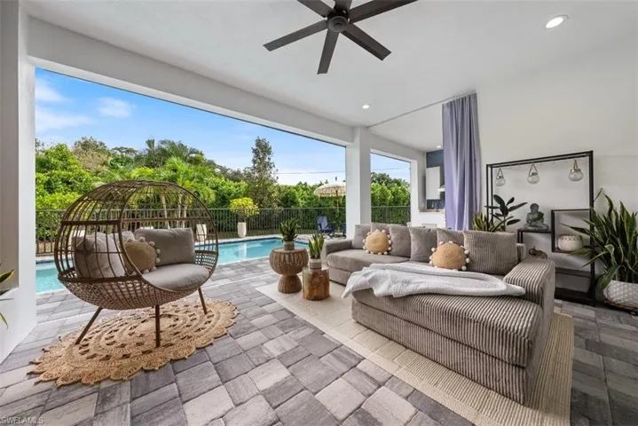 Large covered area with ceiling fan and electric screens.
