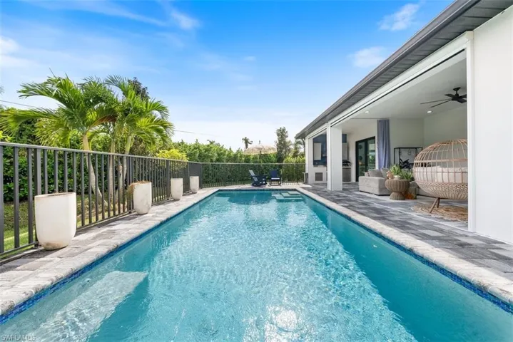 View of swimming pool with a patio and ceiling fan