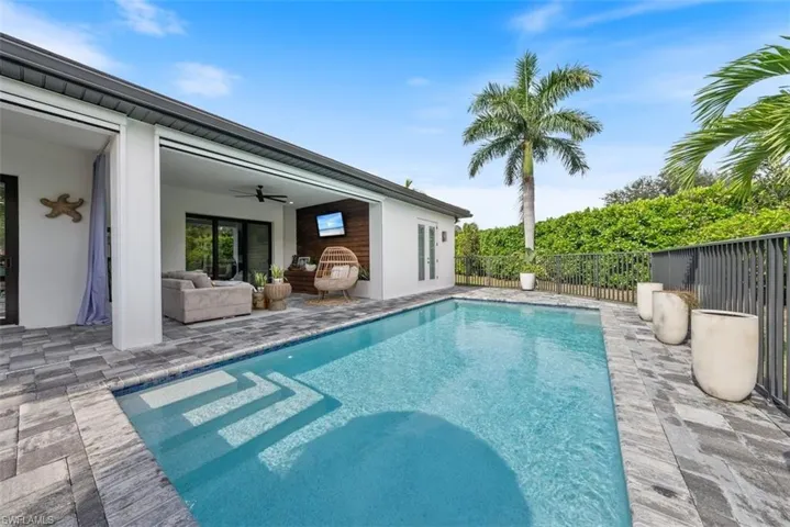 View of pool featuring ceiling fan, an outdoor hangout area, and a patio