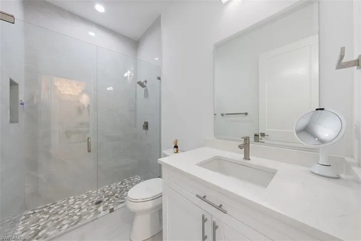 3rd Bathroom with walk in shower, vanity, and toilet