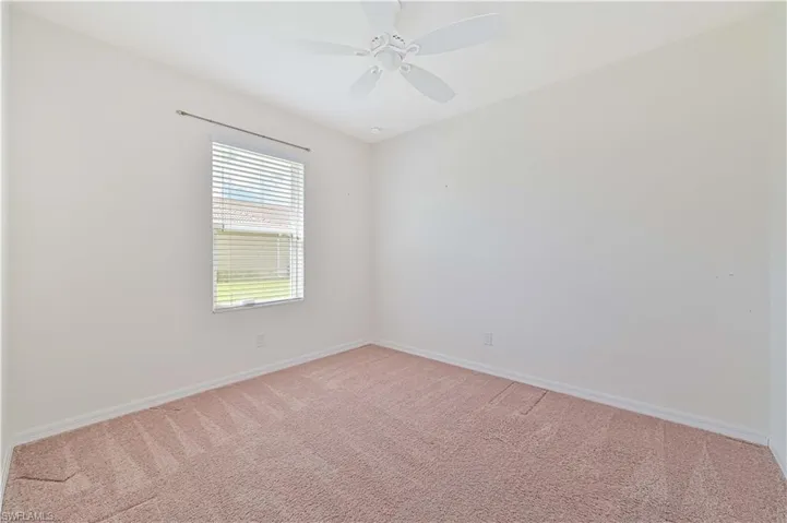 bedroom with light colored carpet and a ceiling fan